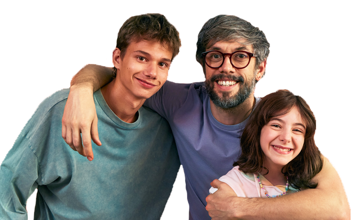 A father with his arms around his son and daughter, all smiling