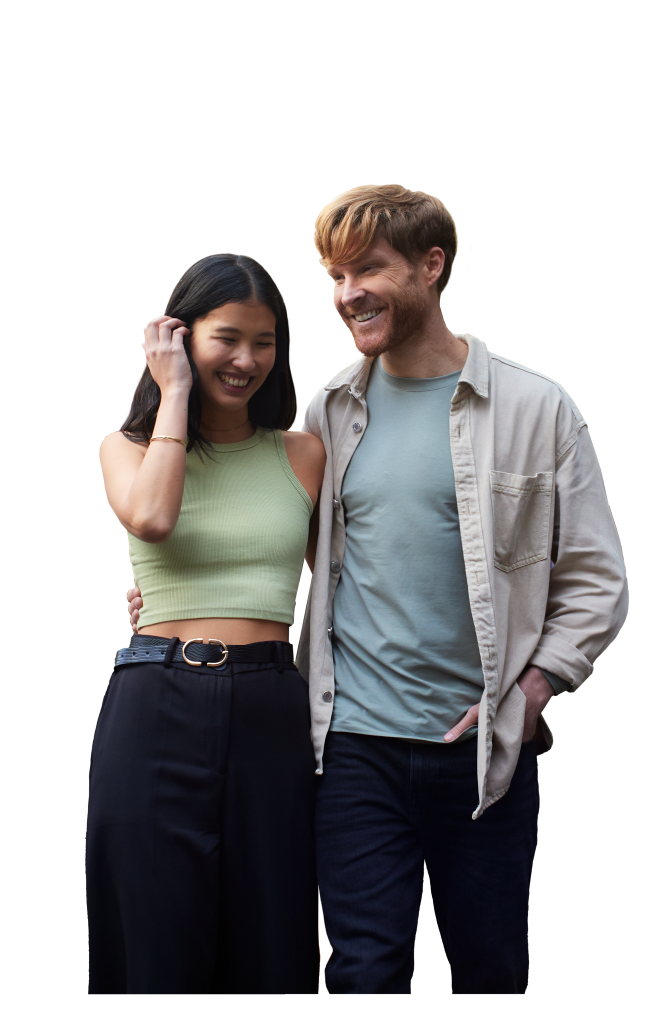 A man wrapping his arm around a woman and both are smiling