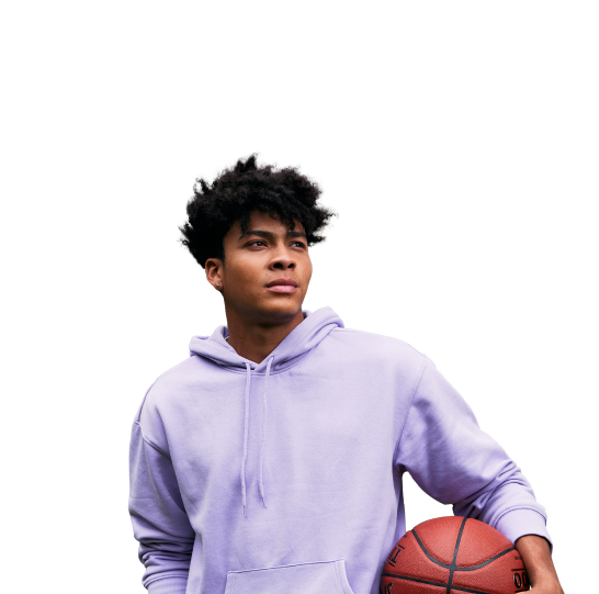 A young man looking into the distance while holding a basketball