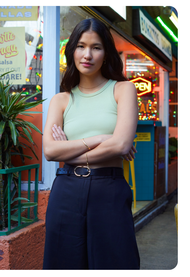 A young woman standing with her arms crossed